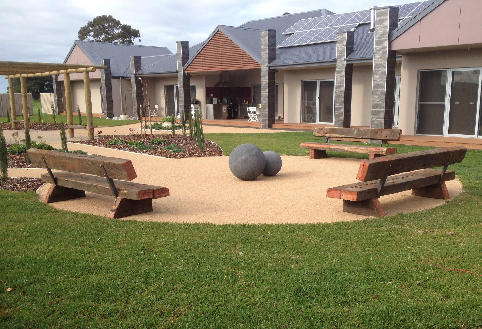 Handcrafted Australian hardwood outdoor furniture in a garden setting