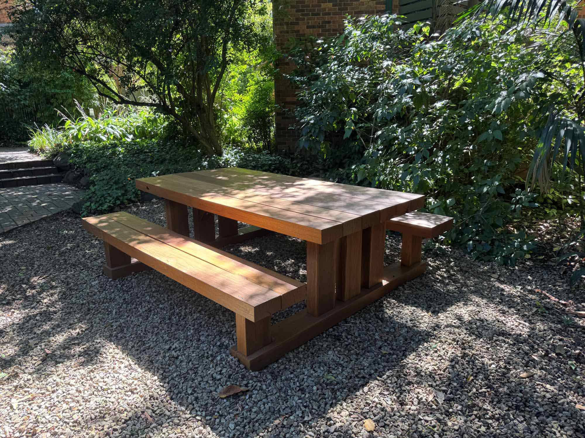 Handcrafted Australian hardwood outdoor furniture in a garden setting